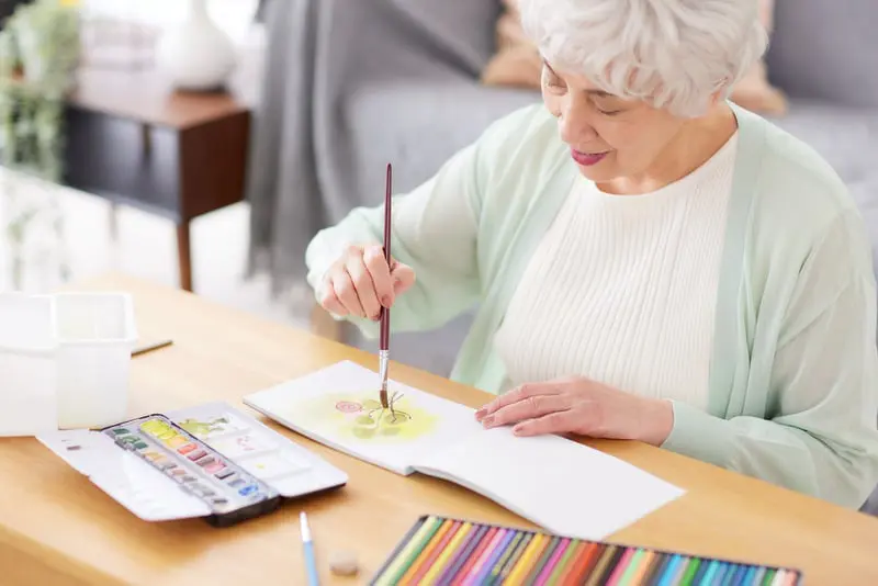 Senior Woman Painting in 475 Management Senior Woman Painting in 475 Management